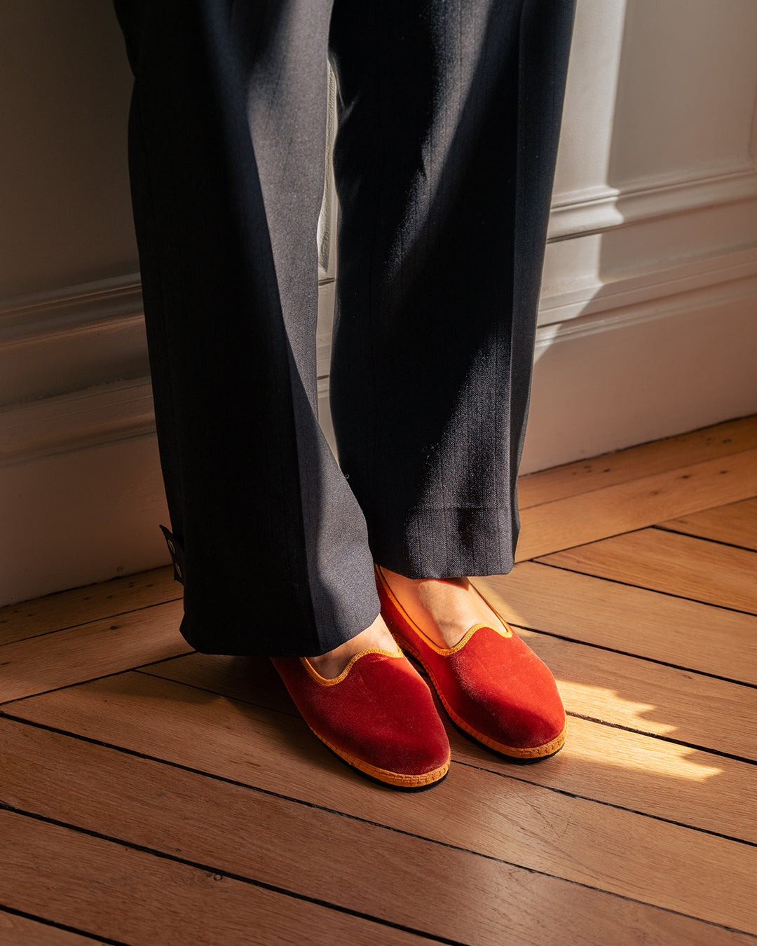 Ambra Friulane in terracotta velvet worn with navy tailored trousers