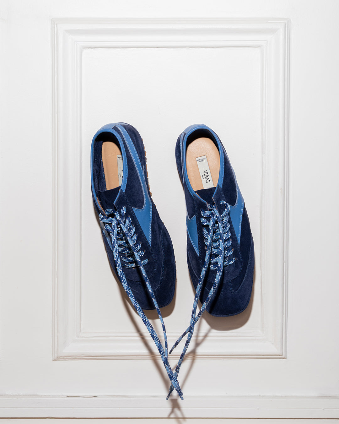 Pair of Trieste Corsa Sneakers in navy suede against a white wall